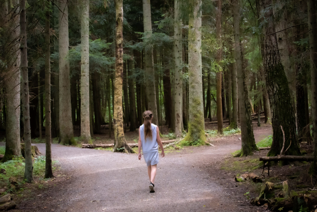 girl walking near the trees