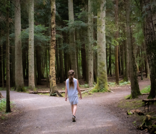 girl walking near the trees